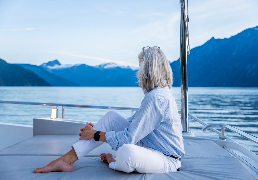 Model on Bow of Yacht with Landscape Bakcground
